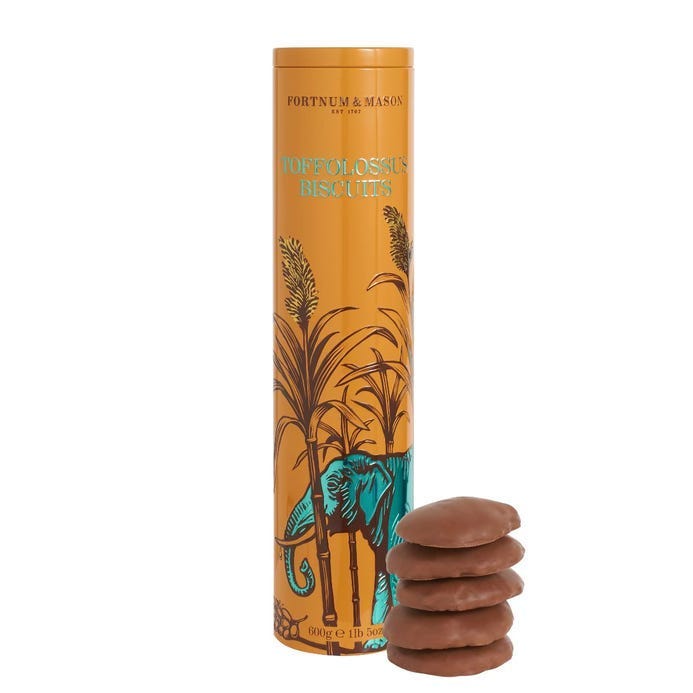 A stack of chocolate cookies next to a tall cylinder

Description automatically generated