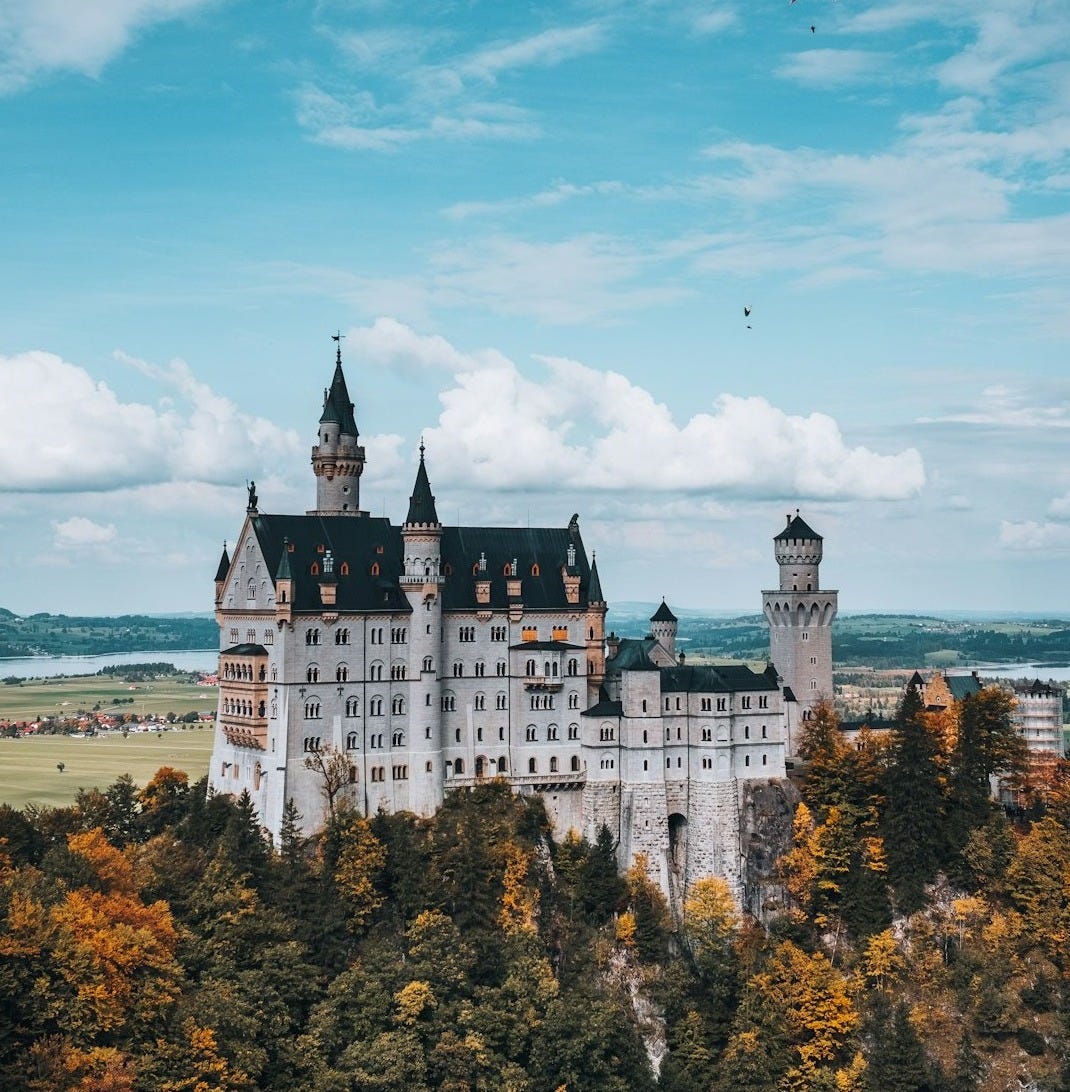 white and blue castle near body of water during daytime white and blue castle near body of water during daytime
