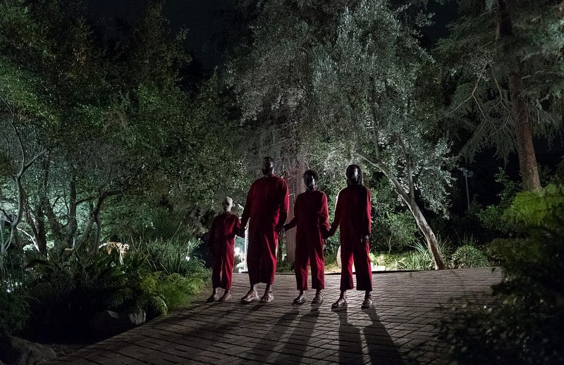 The doppelganger characters standing mencingly in the movie Us / Universal Pictures