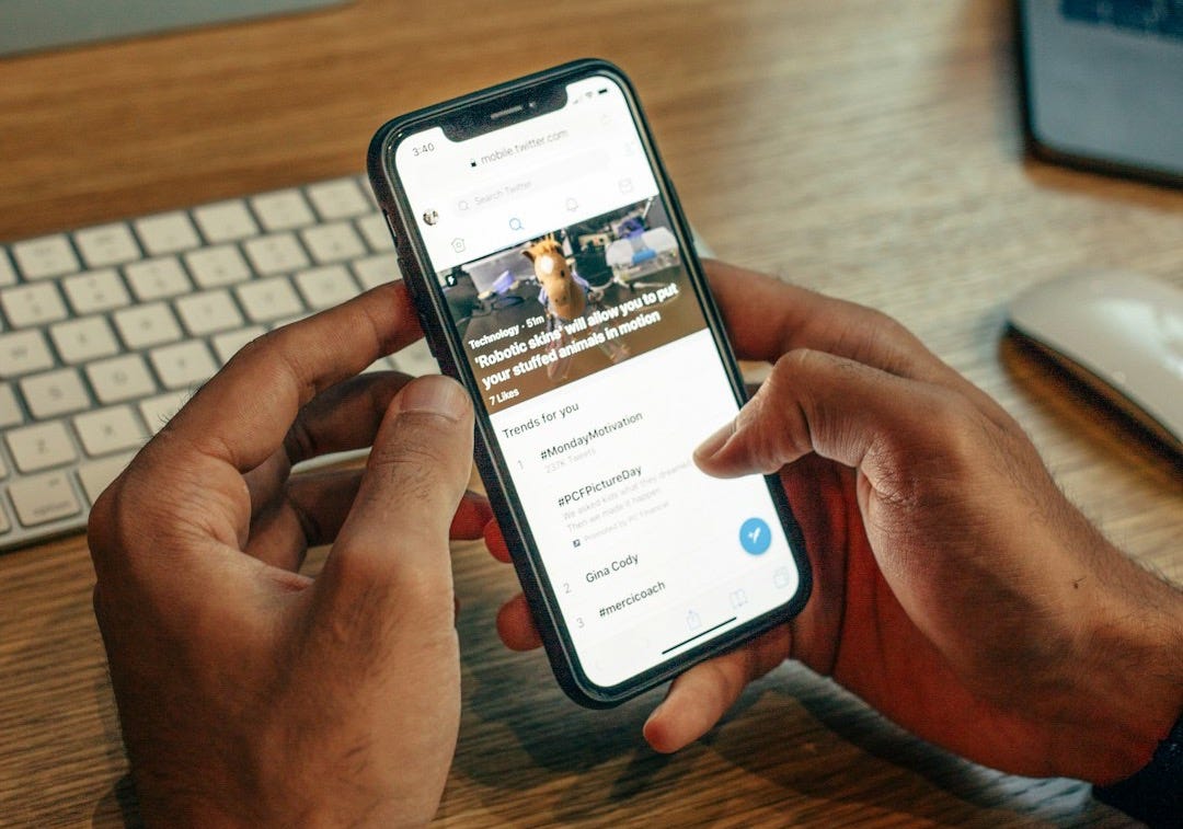 person holding iPhone on table