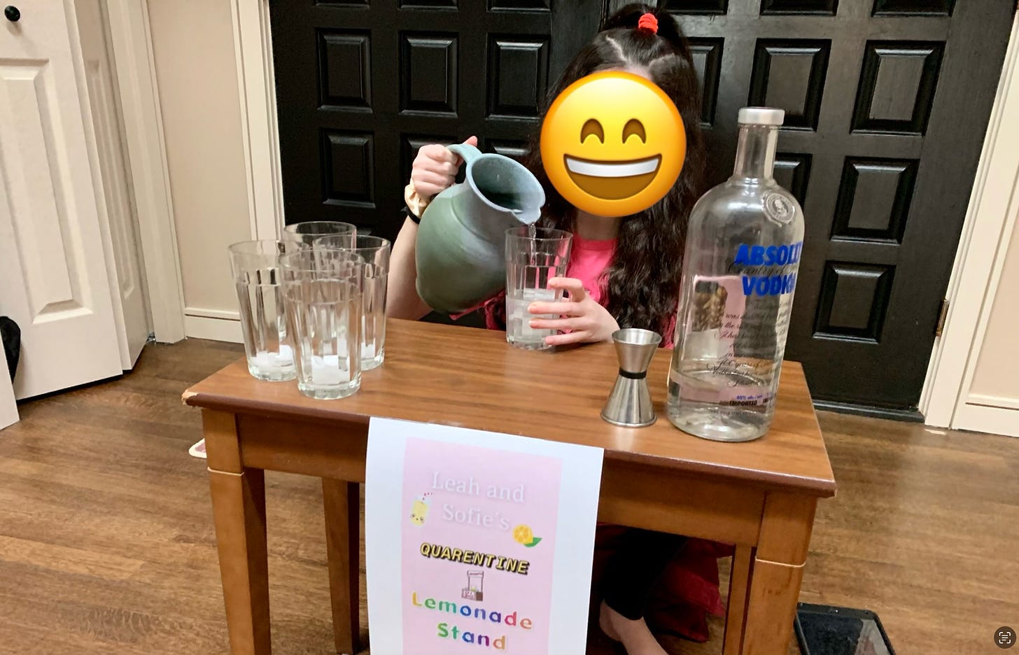 Photo of my daughter at her lemonade stand which along with cups and lemonade hosted a large bottle of vodka