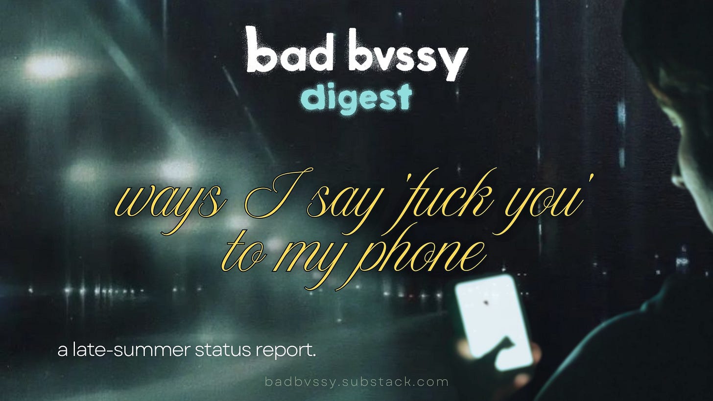 A human looks at their phone in a moody nighttime city atmosphere. Bad Bussy Digest: Ways I Say 'Fuck You' to my Phone. A Late Summer Report.