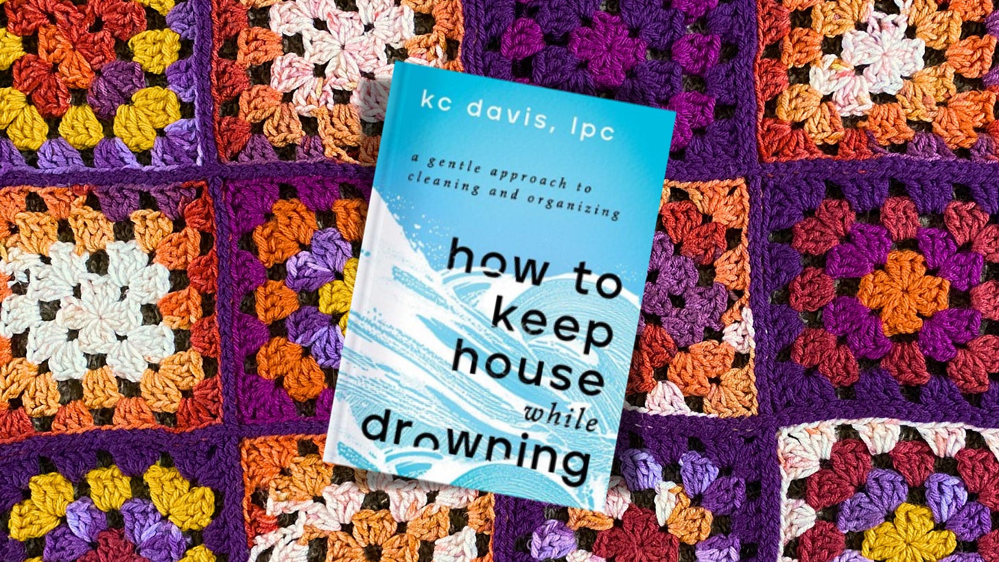 A blue and white copy of “How to Keep House Wile Drowning,” superimposed over an orange and purple crochet background. 