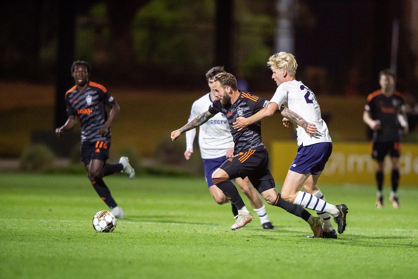Orange County SC's Emil Nielsen tries to get past a Capo FC defender in the 2023 U.S. Open Cup.