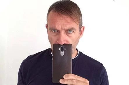 Photo of Dabbsy holding a phone under his nose like it was a Hitler moustache.
