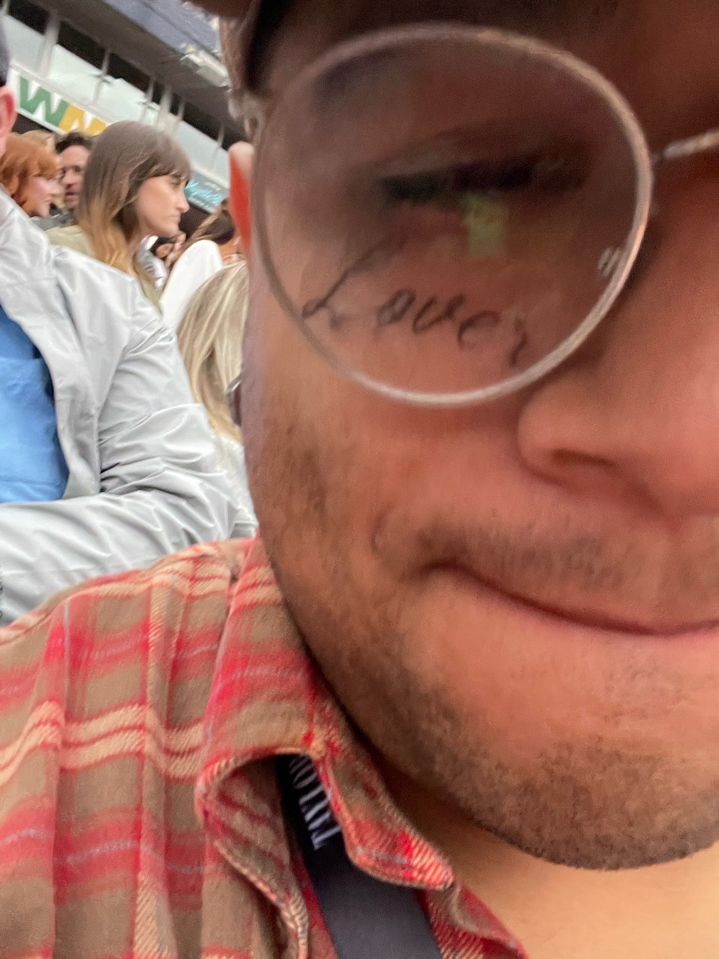 A selfie of Joel Moisa with a temporary face tattoo. It says "Lover."