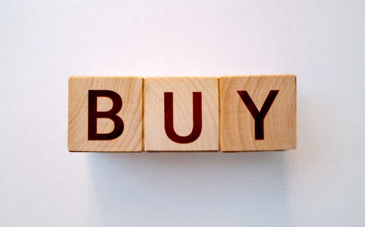 "Buy" word made by wooden blocks
