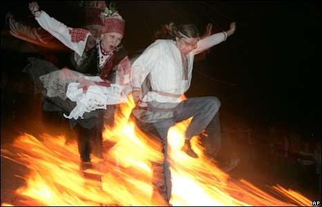 Belarusians jump over a fire during celebrations to mark the summer solstice in Bobr, east of Minsk