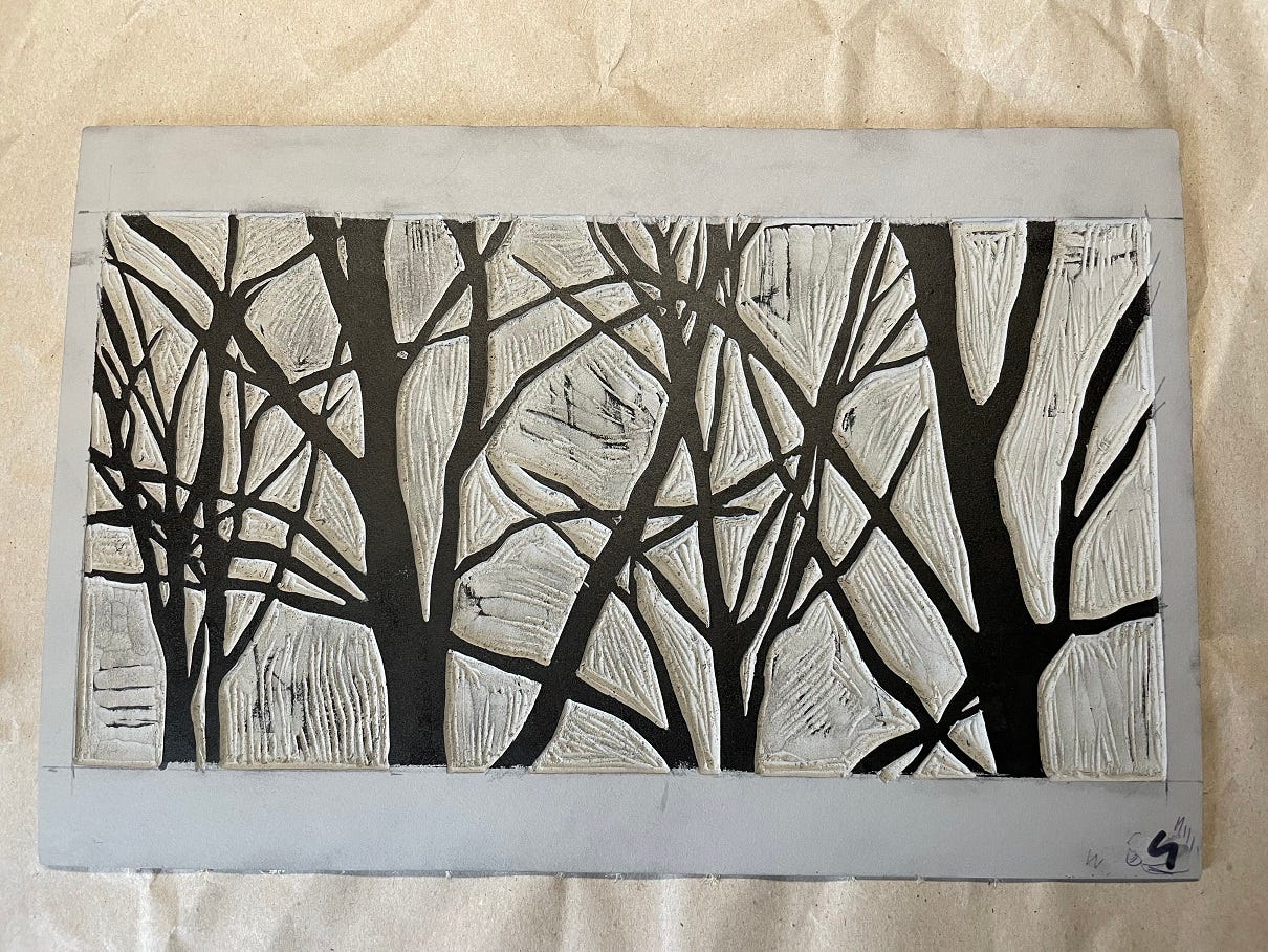 Photo of a linocut with black ink on it.