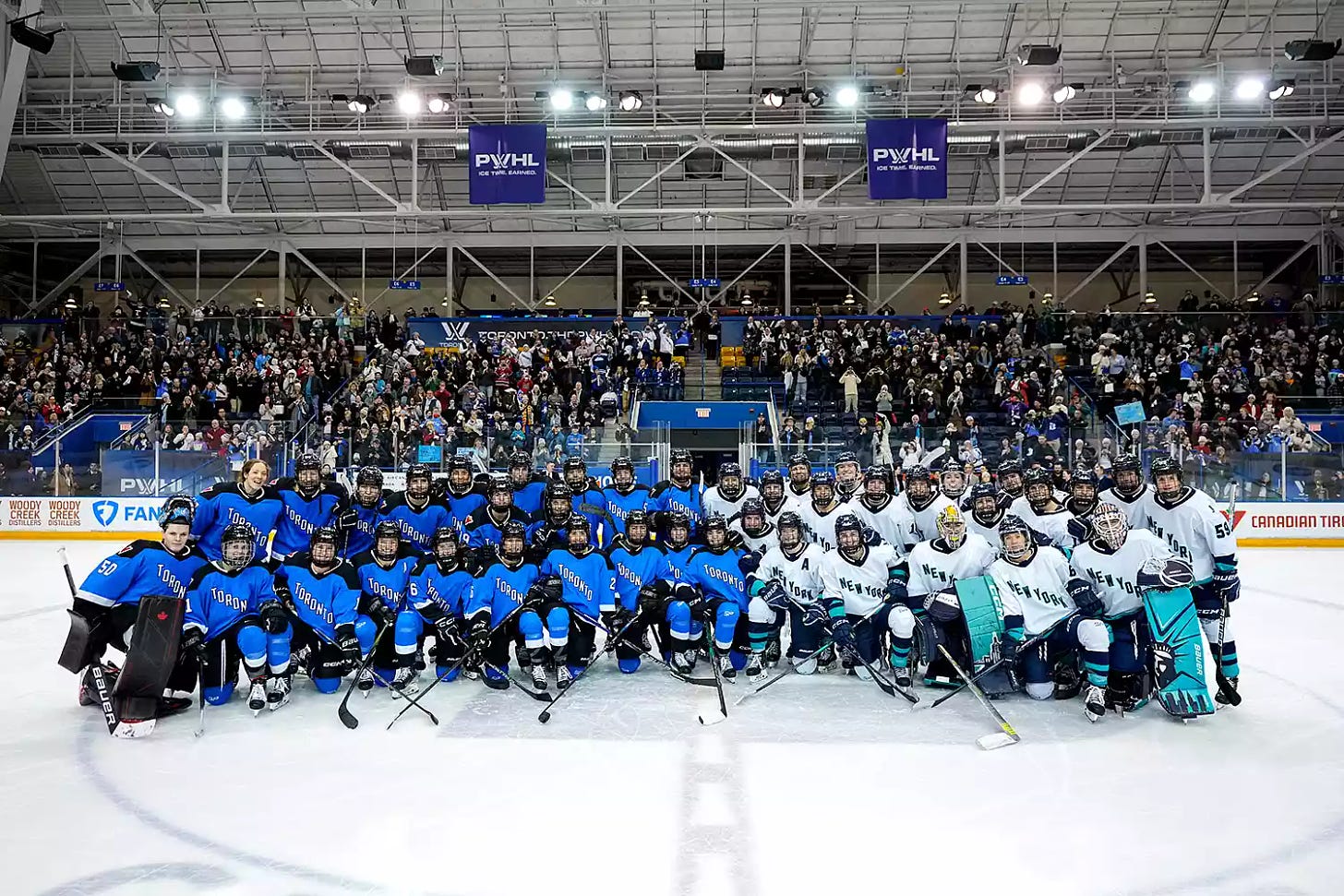Toronto and New York players pose for a group photo after the inaugural PWHL hockey game at the Mattamy Athletic Centre on January 1, 2024 in Toronto, Ontario, Canada. 