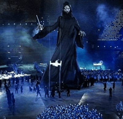 A person in a black robe with a sword in the air

Description automatically generated