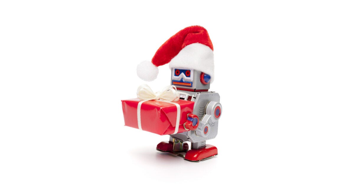 Retro tin toy santa robot holding christmas present