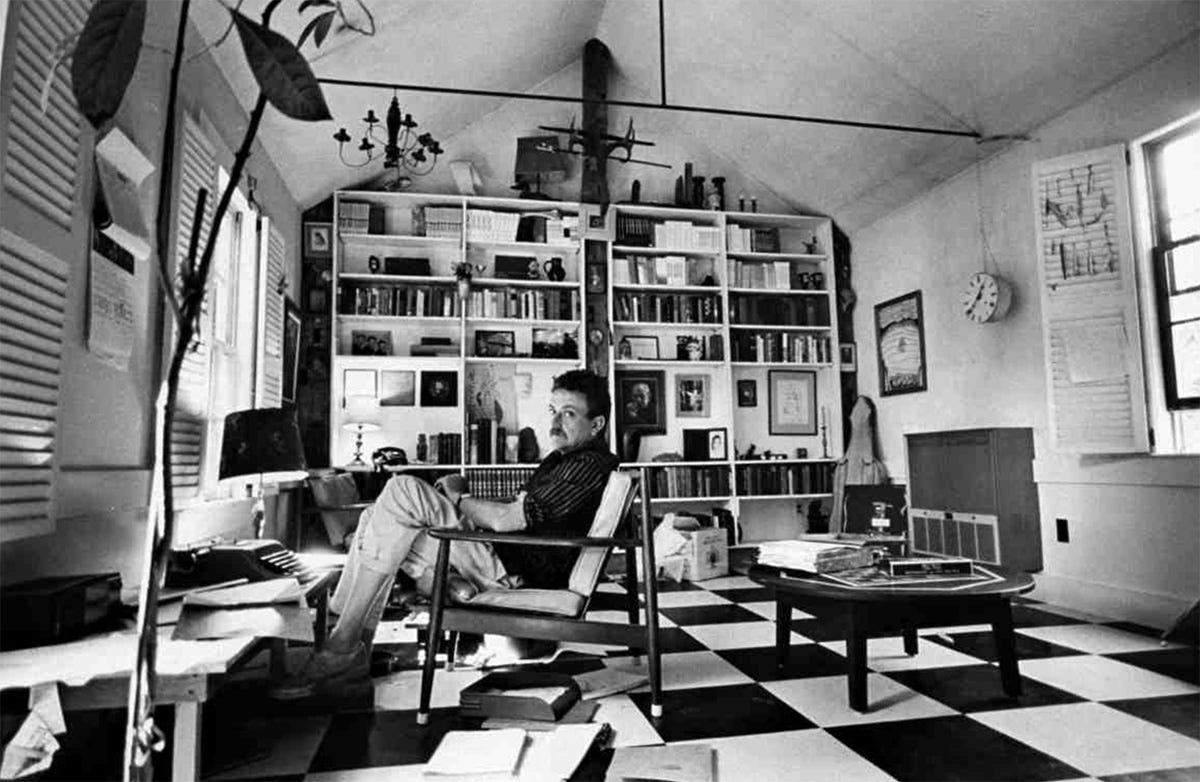 Kurt Vonnegut sitting in his house with typewriter and books