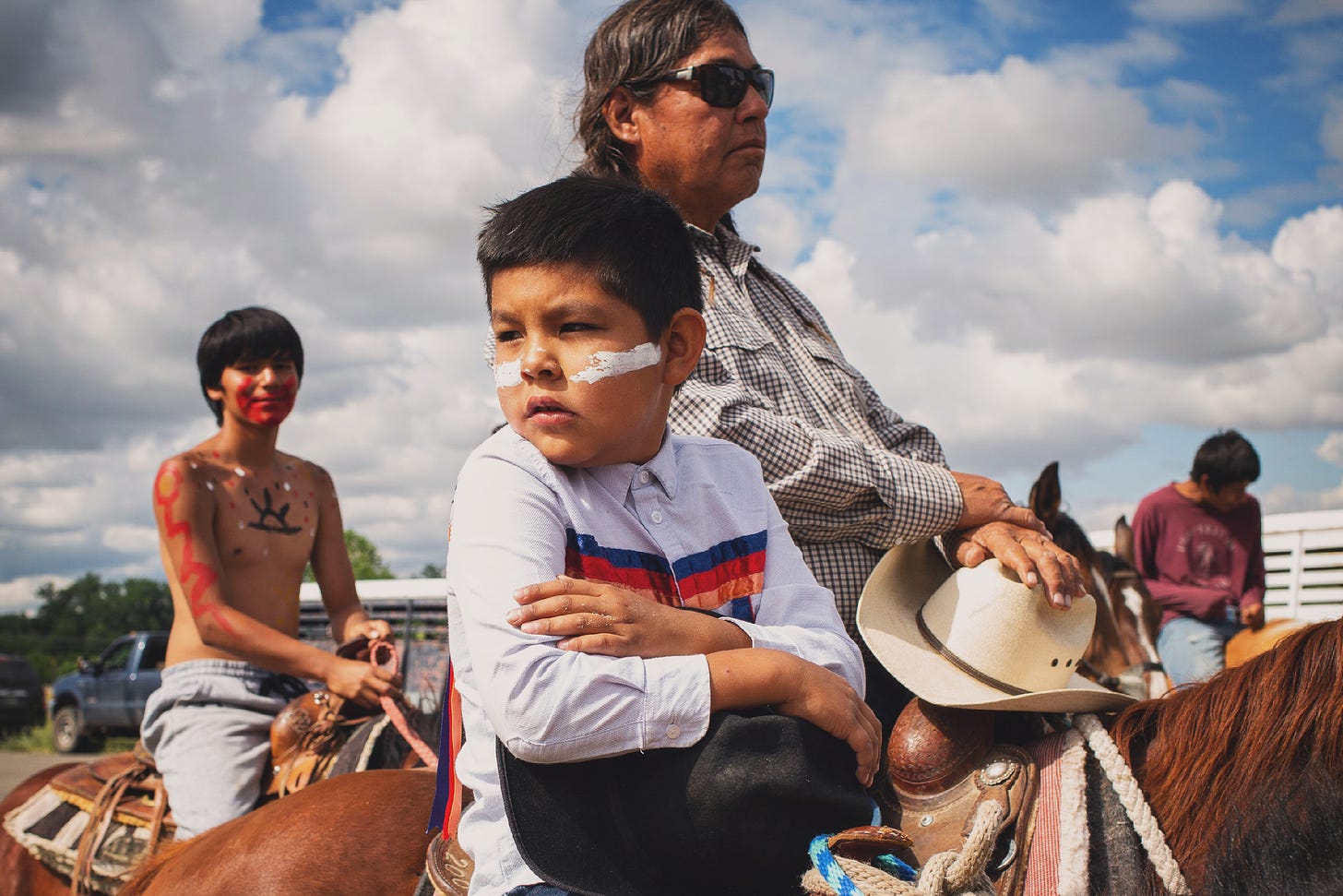 Allison Sage who is Arapaho, with his grandson on the Little Big Horn ride in Montana.