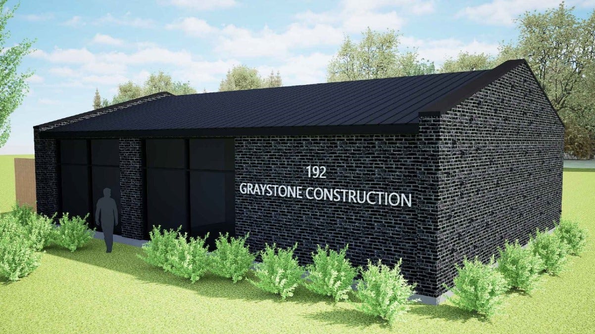 A rendering of a black brick building