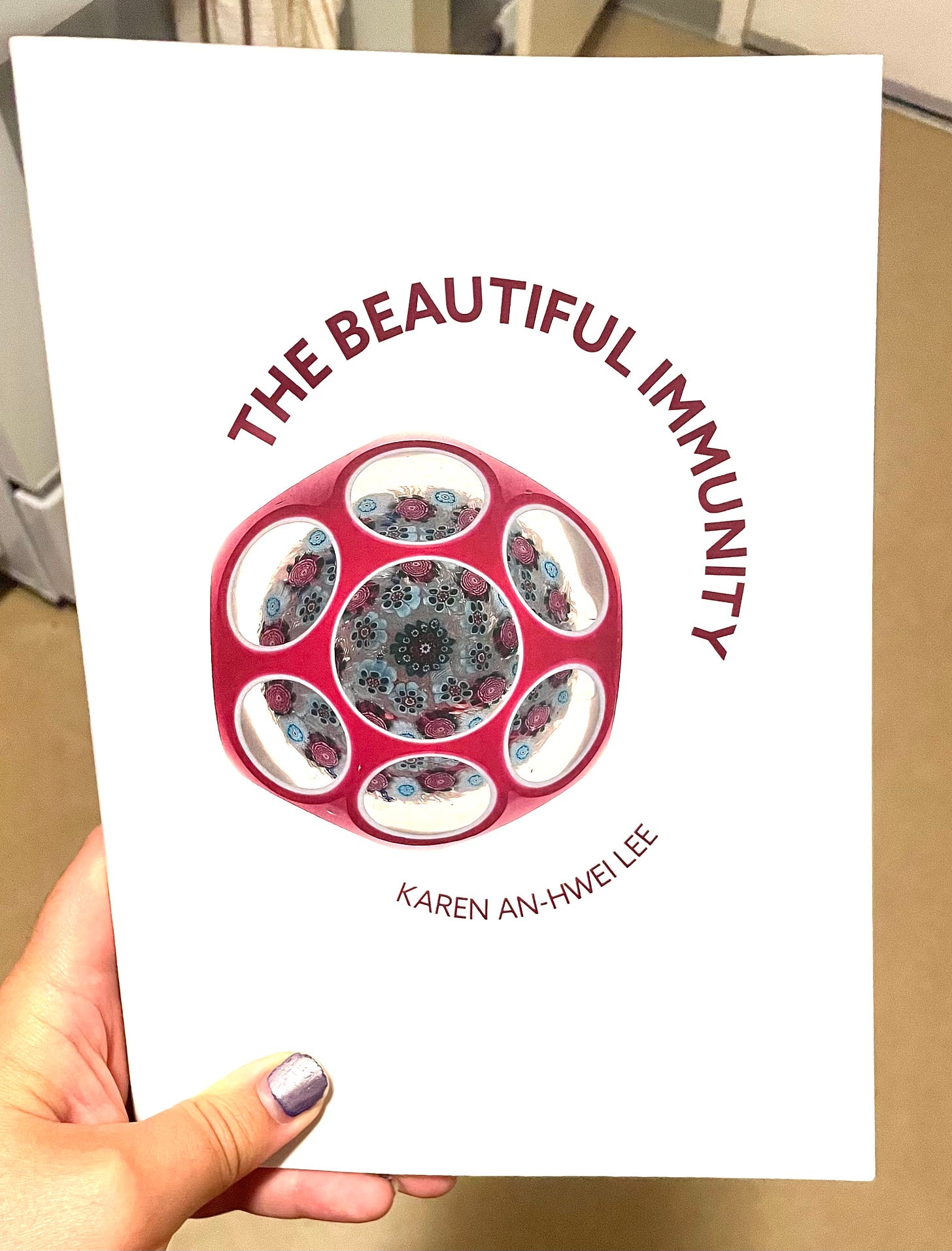 Me holding my copy of "The Beautiful Immunity" by Karen An-Hwei Lee