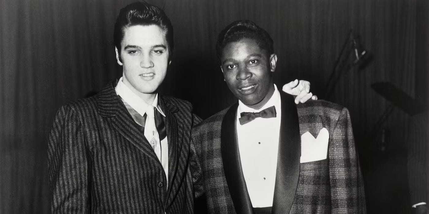 A very young Elivis with his arm around a very young B.B. King; both of them are in sharp suits