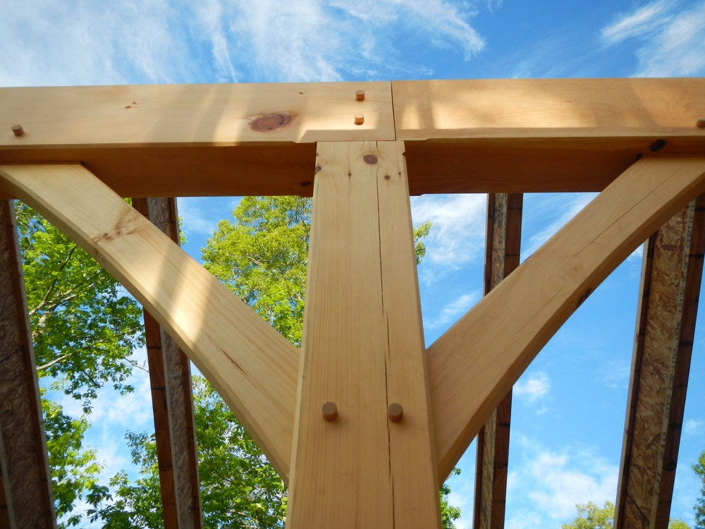 Close-up of a several timber beams joined together.