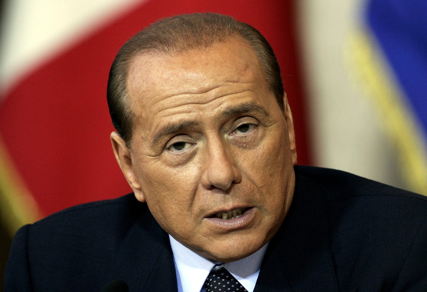 Italian Prime Minister Silvio Berlusconi answers a journalist's questions during a news conference in Rome