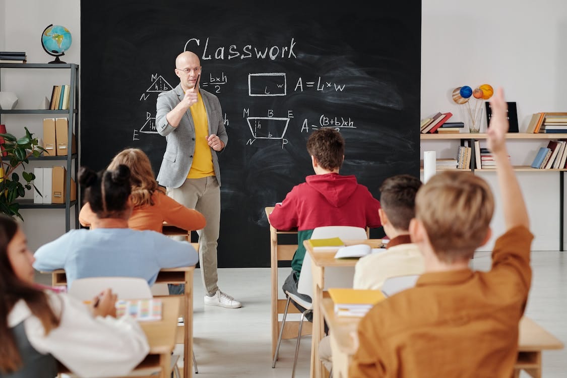Free Teacher Asking a Question to the Class Stock Photo
