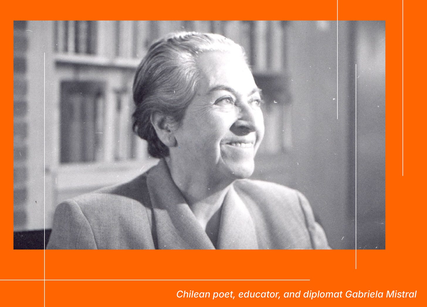 A black and white photo of Gabriela Mistral in profile. She is an older white Latin American woman with white hair pulled back, arched brows, and a smile. She wears a blazer and stands in front of a bookshelf.