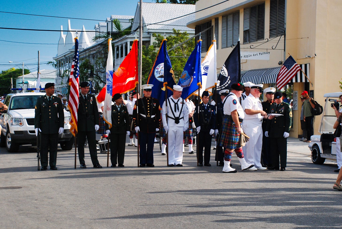 Group of U.S. military veterans in uniform and color guard with American and military flags at the Veterans Day Parade in Key West, 2008, coinciding with Election Day when Barack Obama was elected as the first Black president of the United States.