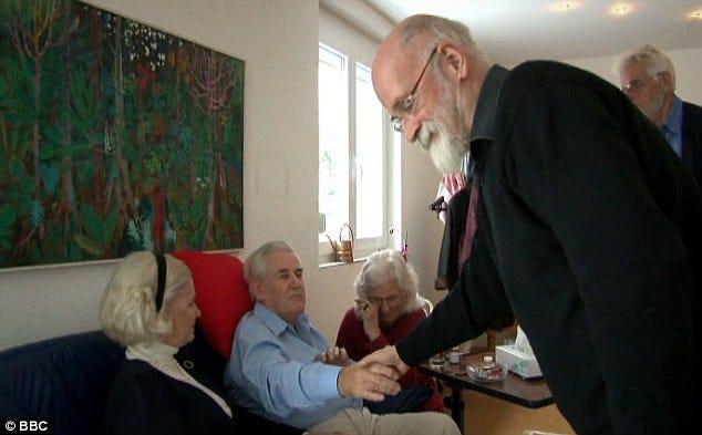 Final moments: Mr Smedley (left) shakes hands with Sir Terry Pratchett at the Swiss clinic