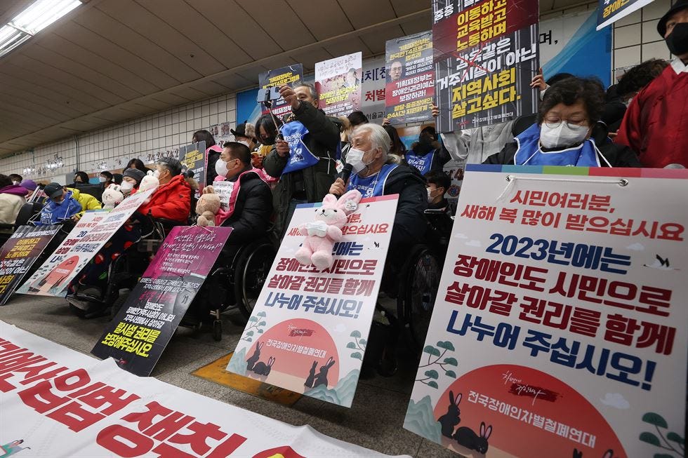 Members of the Solidarity Against Disability Discrimination hold a press conference at a platform of Samgakji Station in Seoul, Jan. 2. Yonhap.