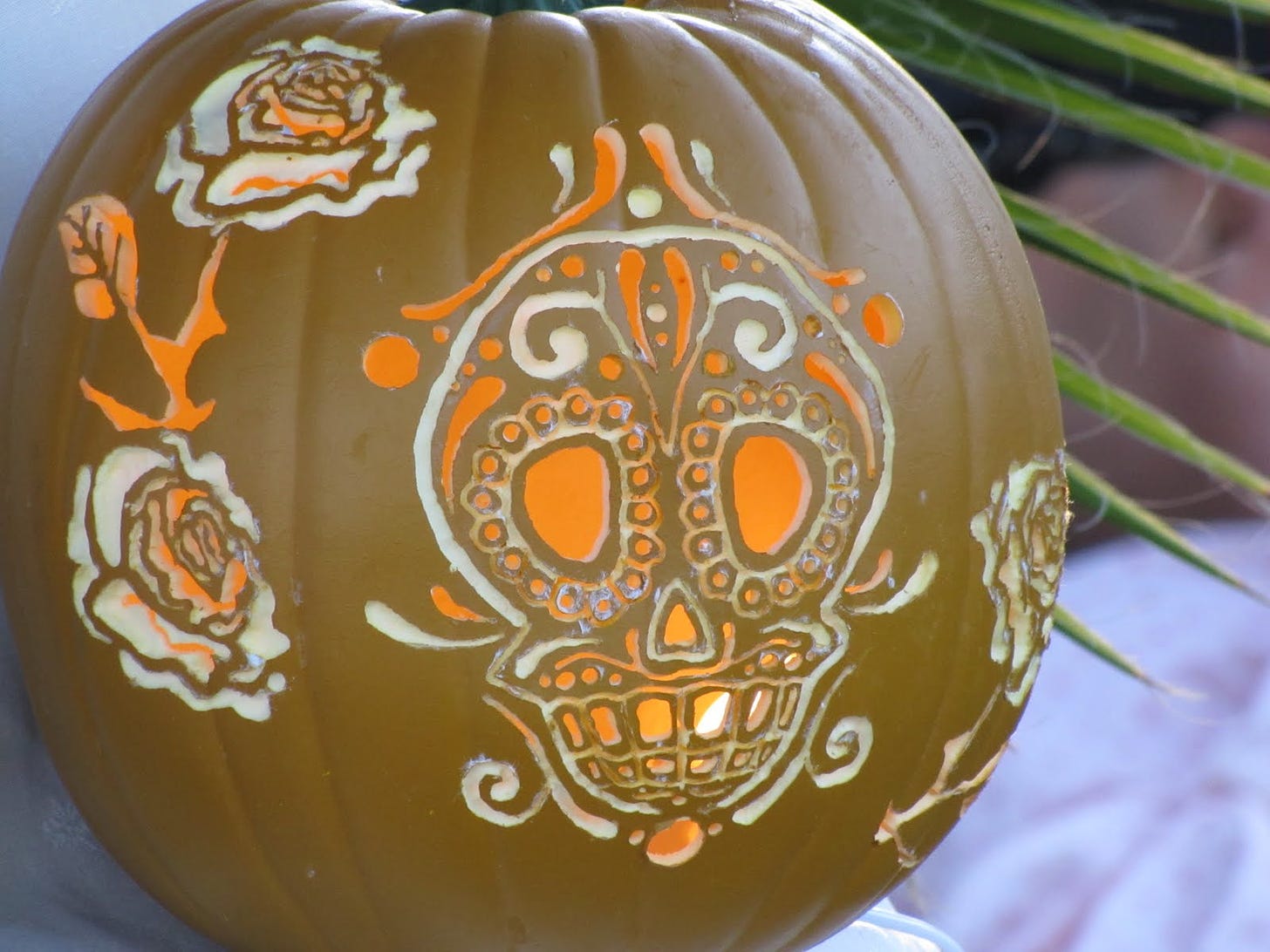 Carved pumpkin with calavera and roses