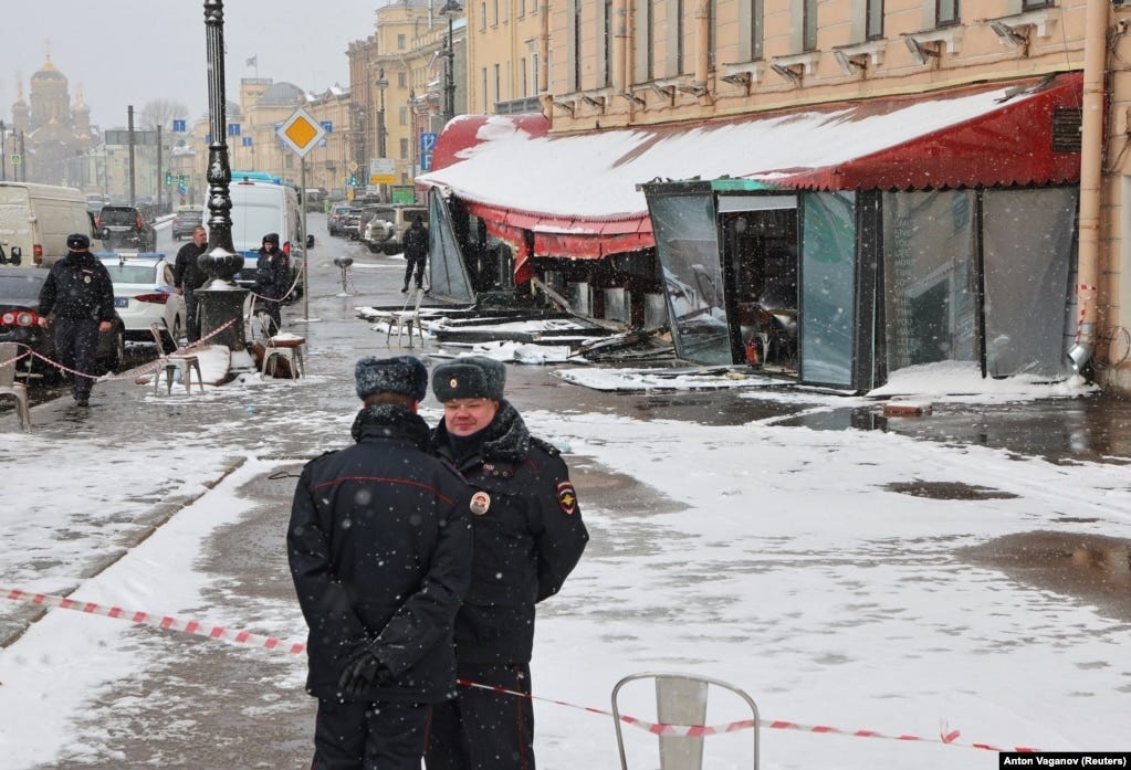 Police officers stand guard at the scene of the explosion.