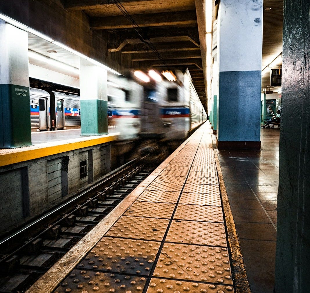 white and green train in train station