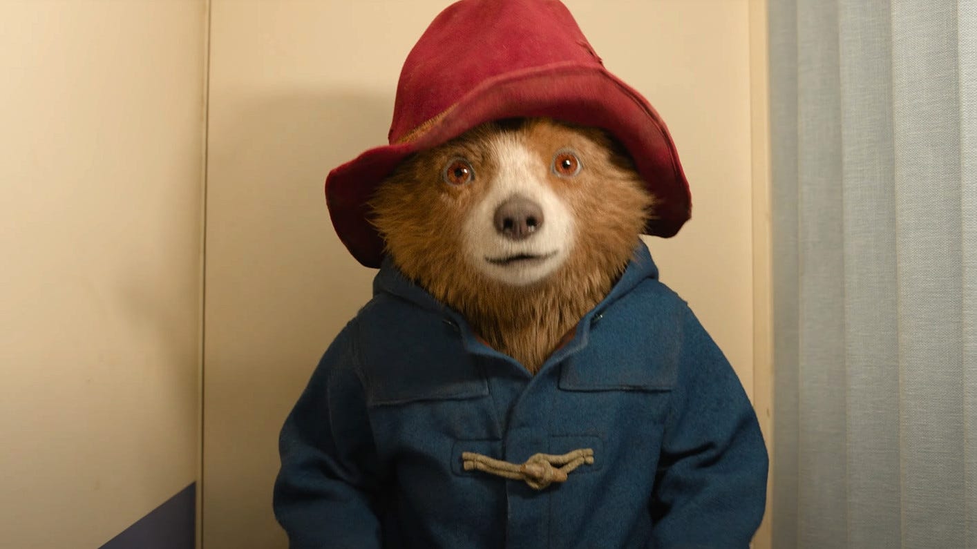 Paddington grapples with a photo booth in his new trailer