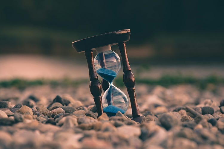 Sand Timer in the sand on a beach.