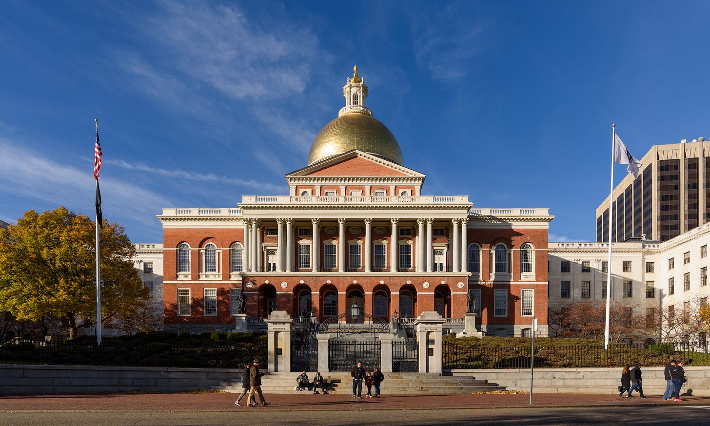 Massachusetts State House photographed from the street: it's a large, Colonial-architecture building with a domed ceiling.