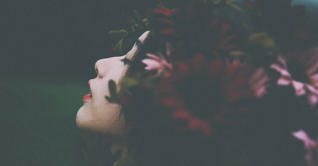 red and pink flower headdress on woman's head