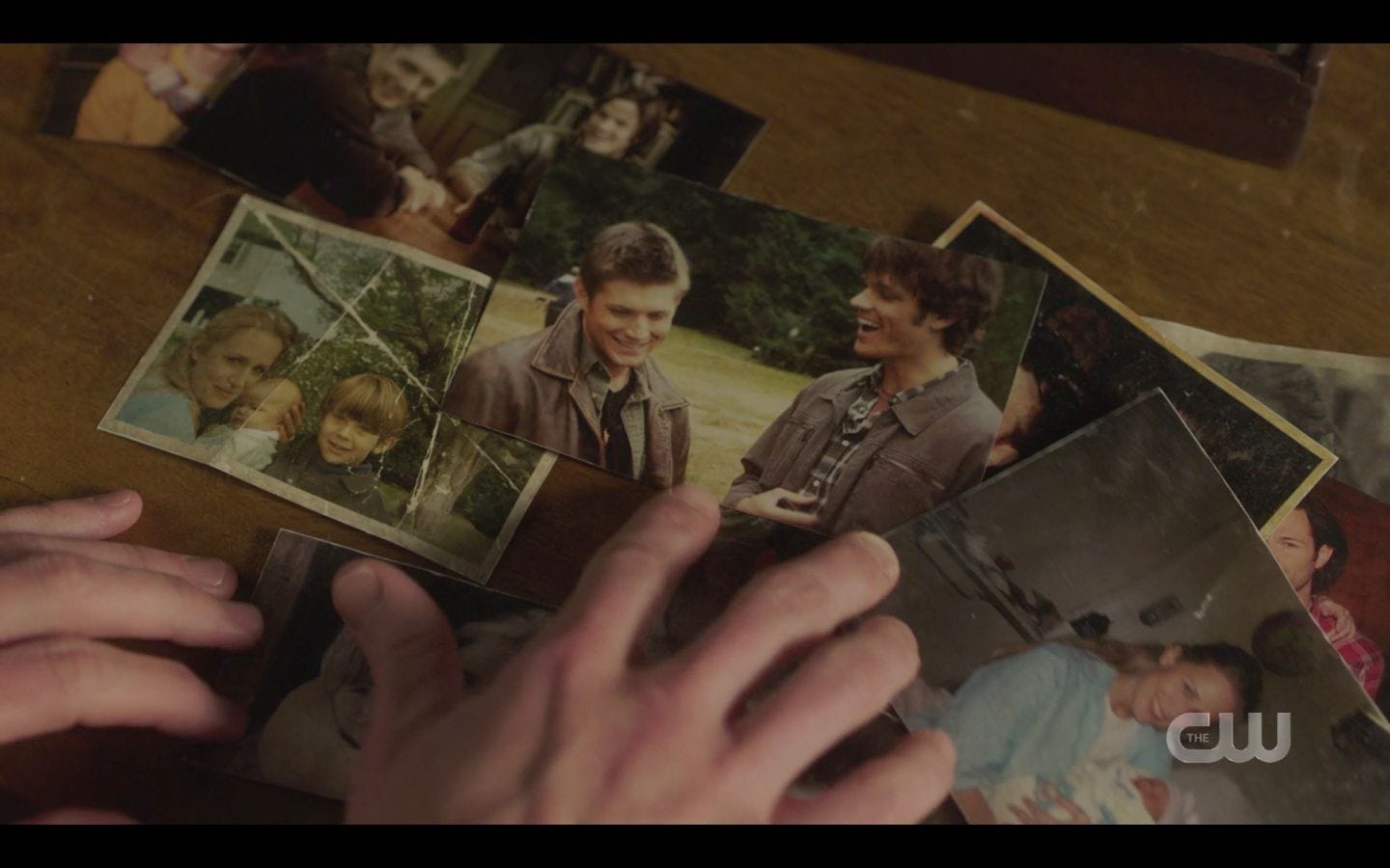 Sam Winchester with old photos of him and dean with Mary SPN 14.18