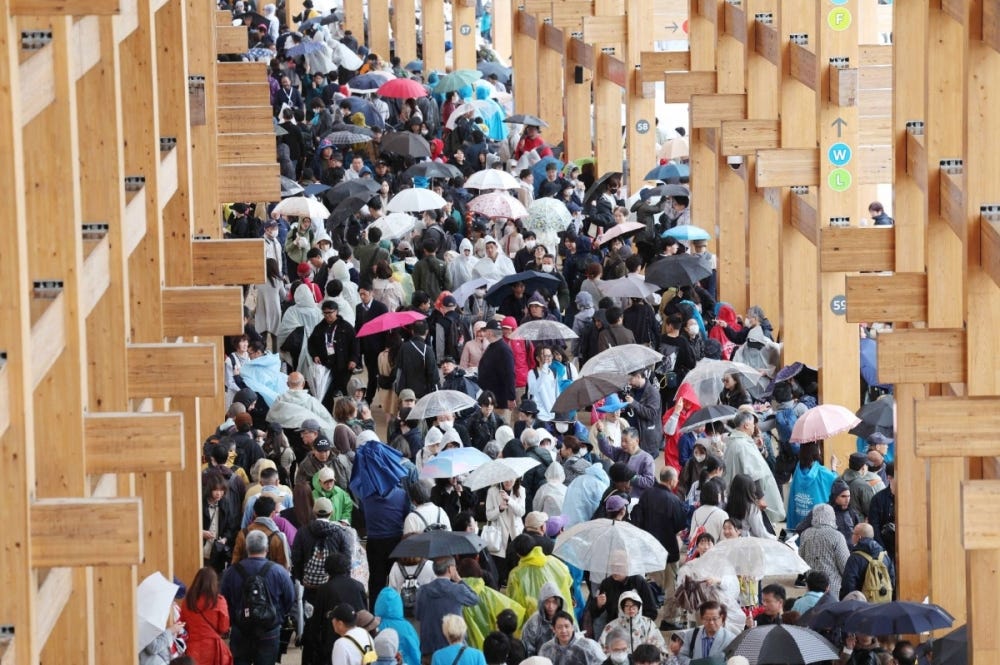 The Grand Ring walkway is crowded with visitors amid rain on the opening day of the Osaka Expo on Sunday.