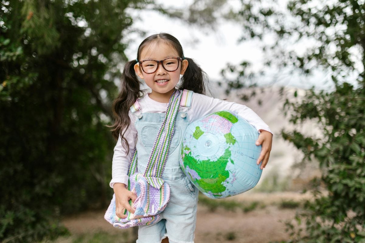 Photo of girl carrying an inflatable globe