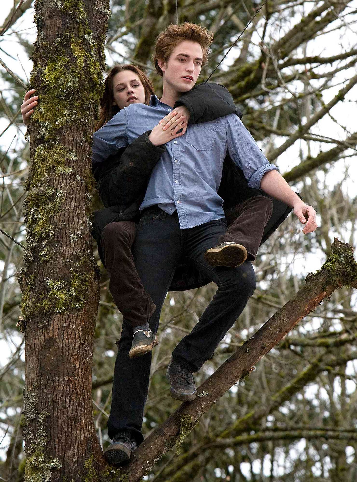 Bella on Edward's back, about to leap off tree
