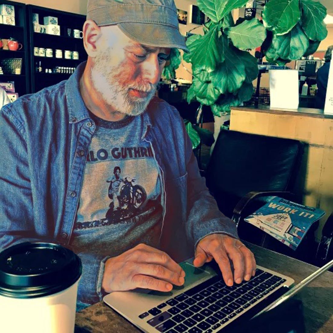 This writer is in his favorite coffeehouse. Photo copyrighted by Alice Tulin