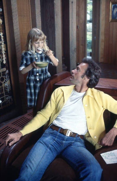 CARMEL-JANUARY 1978; Movie actor and director Clint Eastwood with his daughter at home in Pebble Beach near Carmel, California circa 1978 (Photo by Nik Wheeler/Corbis via Getty Images)