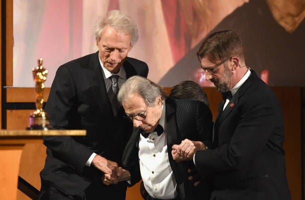 HOLLYWOOD, CA - NOVEMBER 18:  Clint Eastwood presents an award to Lalo Schifrin onstage during the Academy of Motion Picture Arts and Sciences