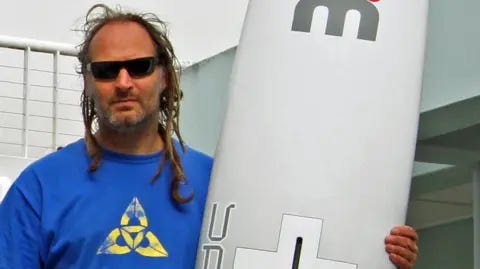 Pete Davis/Creative Commons Farrel O'Shea with a surfboard