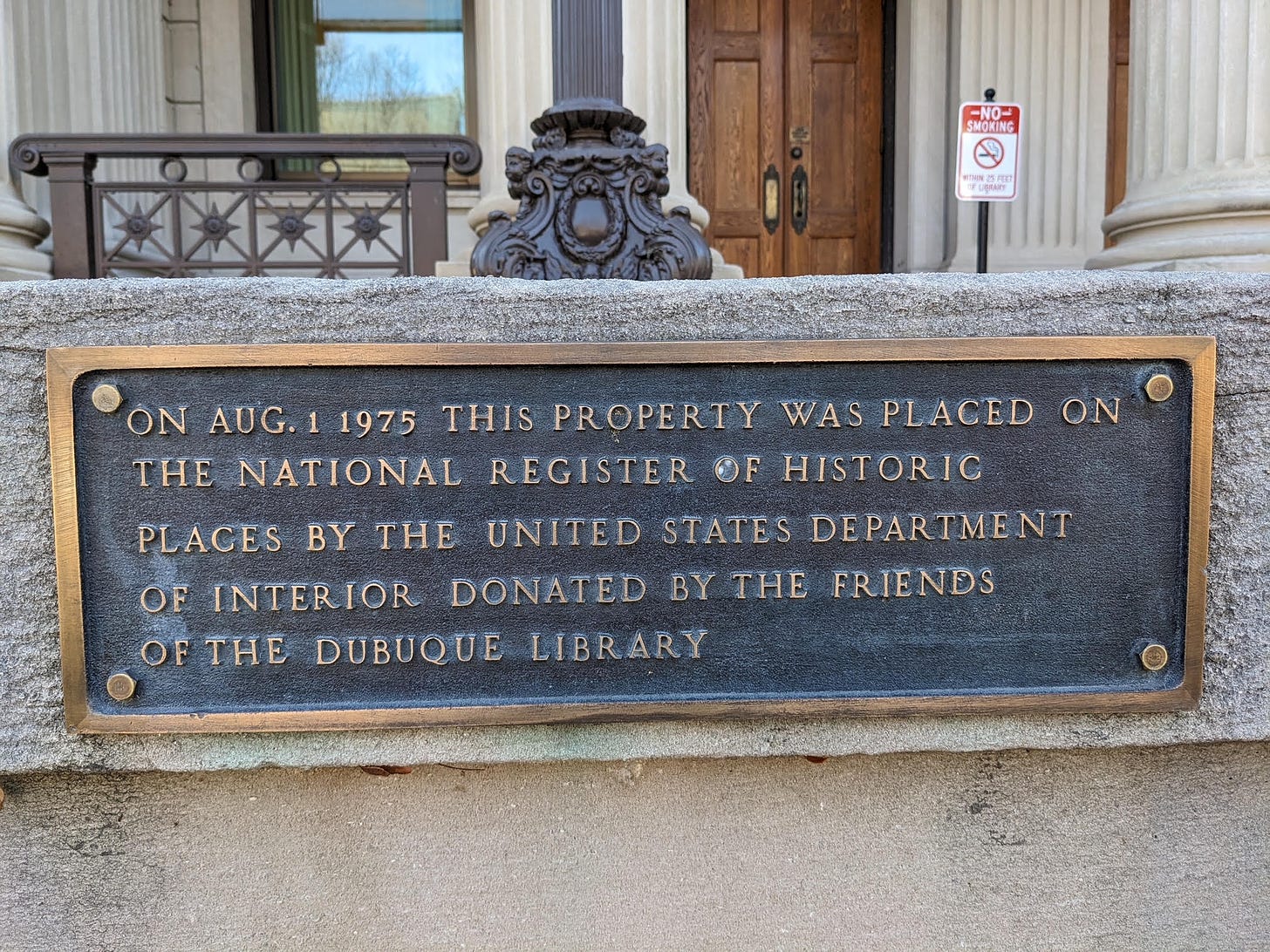 Image of the national register plaque outside of the dubuque public library in iowa.