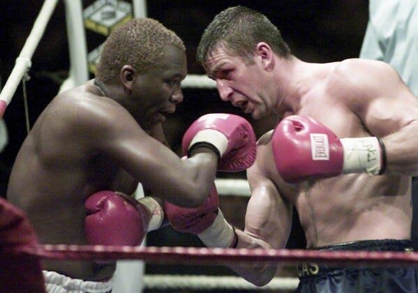 FILE — Defending champion Eric Lucas, right, serves an uppercut to South Africa's Dingaan Thobela, left, during the WBC super middleweight championship on Nov. 30, 2001 in Montreal, Canada. Thobela, a two-weight world champion known as "The Rose of Soweto," has died. He was 57. (AP Photo/Paul Chiasson, File)