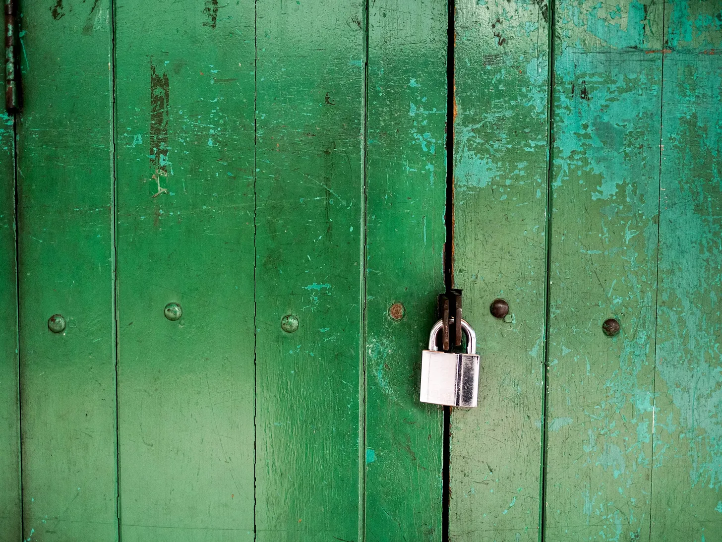 Locked green wooden door by Rob King from Unsplash