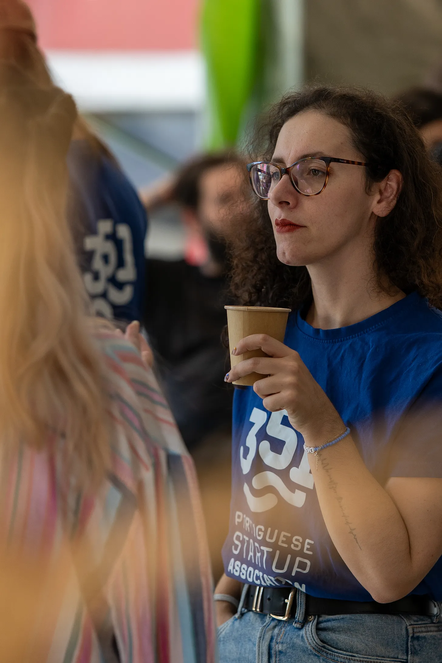 penelope with a serious face holding a coffee