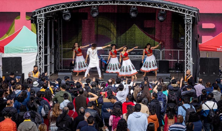 Dancers performing on stage in front of a crowd at the Wembley Diwali Festival