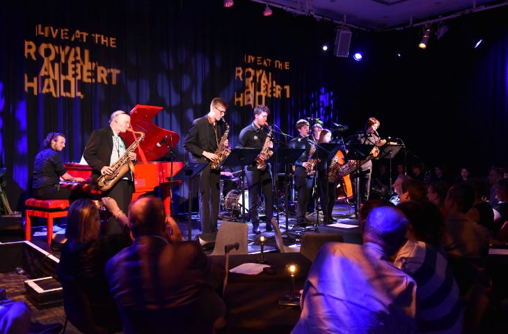 A band on stage in a small venue within the Royal Albert Hall