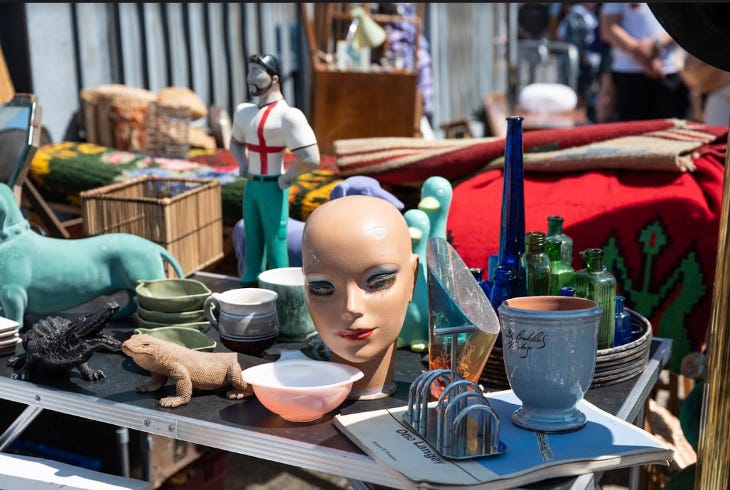 A stall displaying several items including a toast rack and a mannequin's head